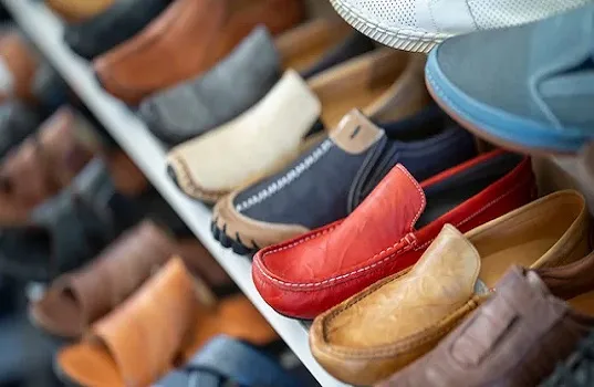 Organised wooden shoe rack placed neatly in the southwest corner of a house as per Vastu.