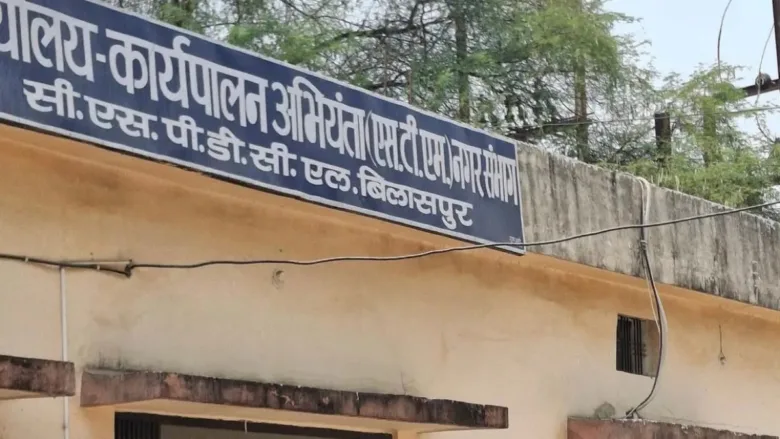 Officials reviewing fake attendance records in electricity department wage payment investigation