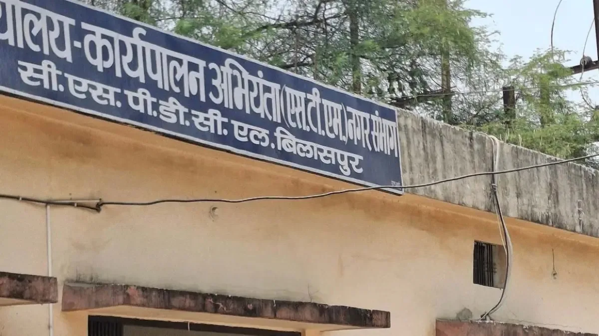 Officials reviewing fake attendance records in electricity department wage payment investigation