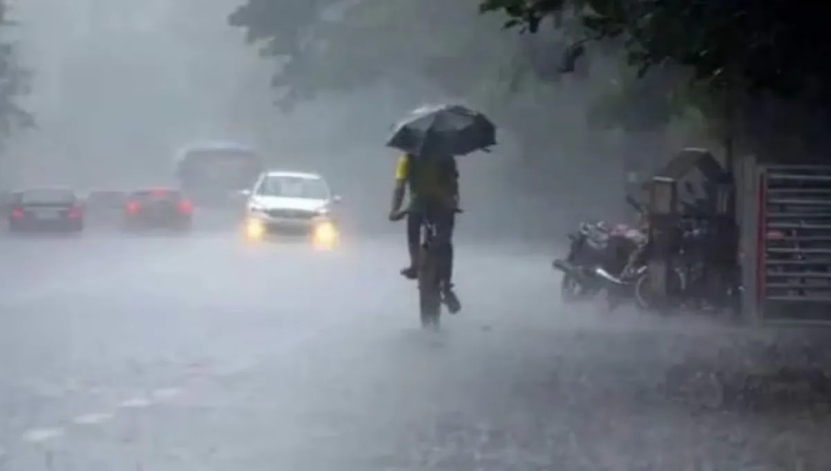 Heavy rain falling on wet city roads in Raipur Chhattisgarh with dark monsoon clouds above.