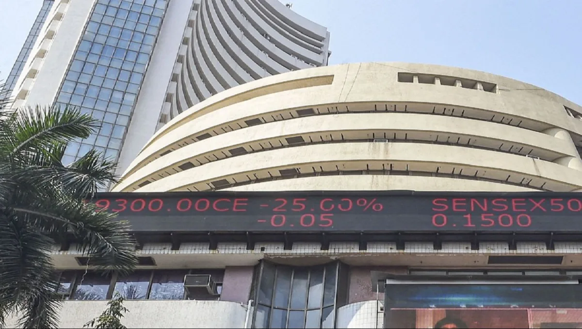 Stock market trading screen showing red dip chart on a laptop monitor in a financial office.