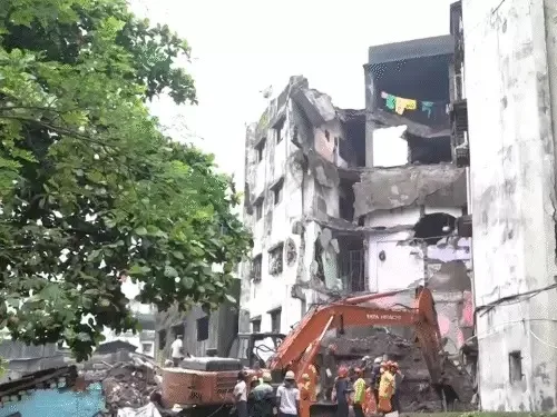 Rescue teams operating at the site of a collapsed four-storey building in Bhivandi.