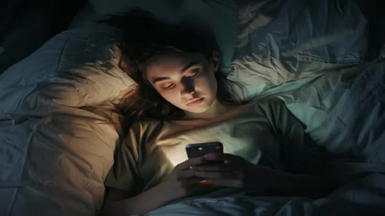 Person avoiding mobile phone one hour before bedtime for better sleep