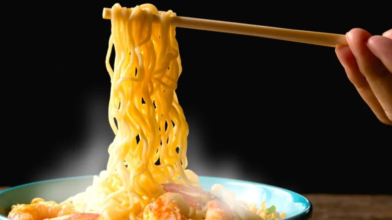 Instant noodles with ramen bowl and Momofuku Ando's invention history