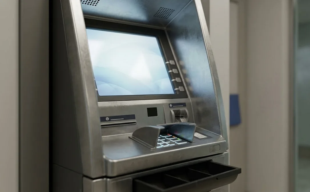 SBI ATM machine card insertion for cash withdrawal and balance inquiry.