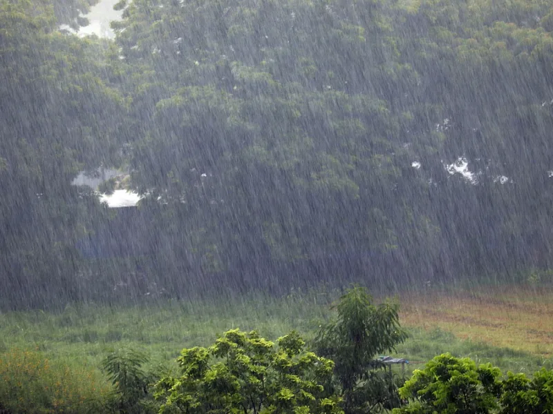 Heavy monsoon rainfall in Chhattisgarh with overflowing river and cloudy sky