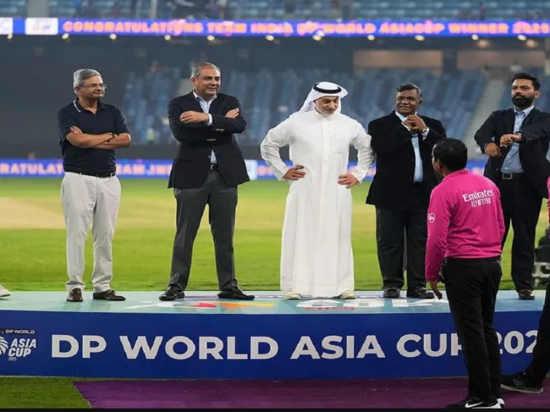 Mohsin Naqvi waits with the Asia Cup trophy during the post-match presentation after India's women's Asia Cup final victory.