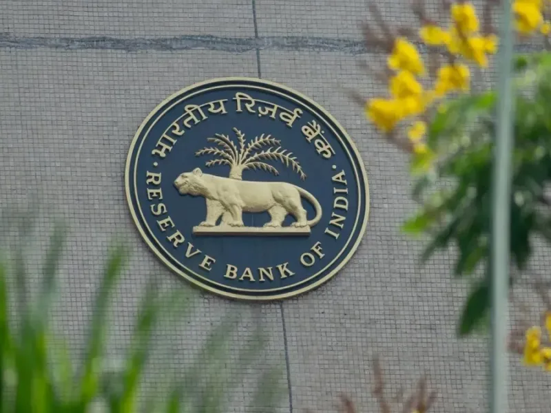 RBI building with Indian rupee notes and US dollar bills representing new forex rules to support the Indian rupee